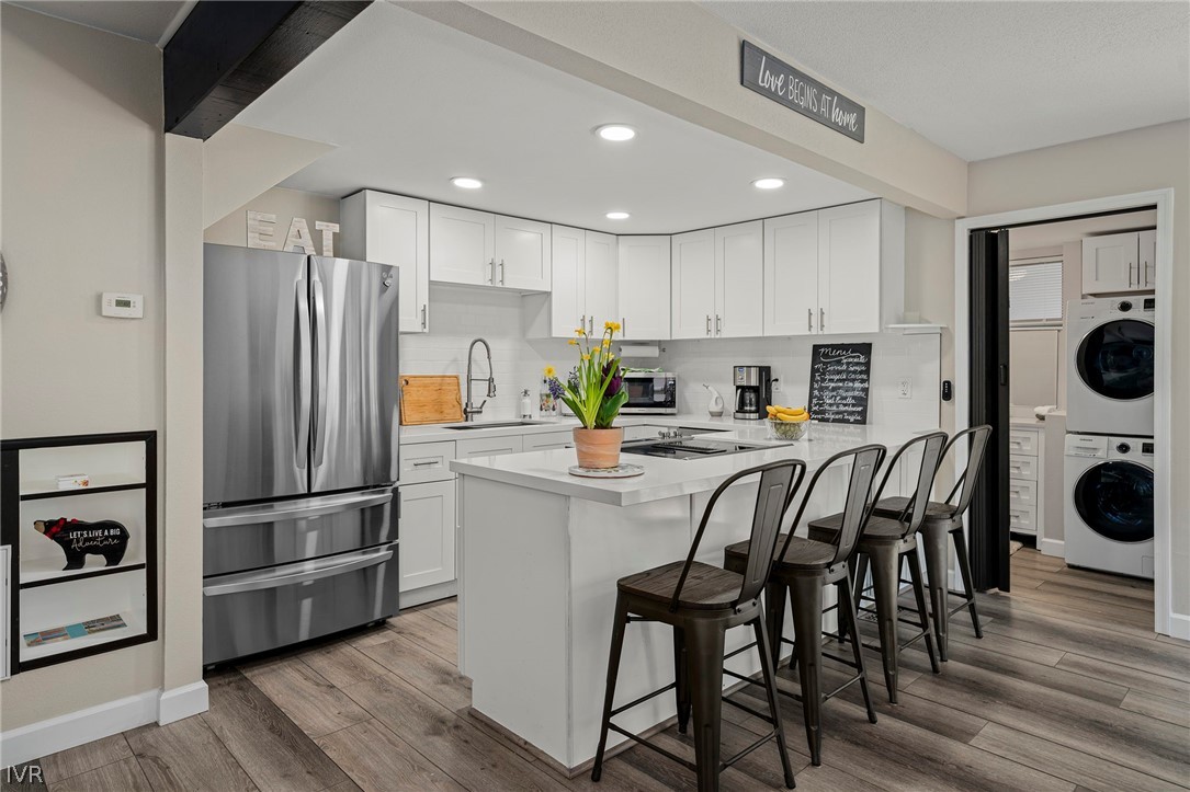 806 Oriole Way, Unit 16 Incline Village, NV 89451 - Photo 5 of 17 a kitchen with kitchen island stainless steel appliances a refrigerator and a stove top oven