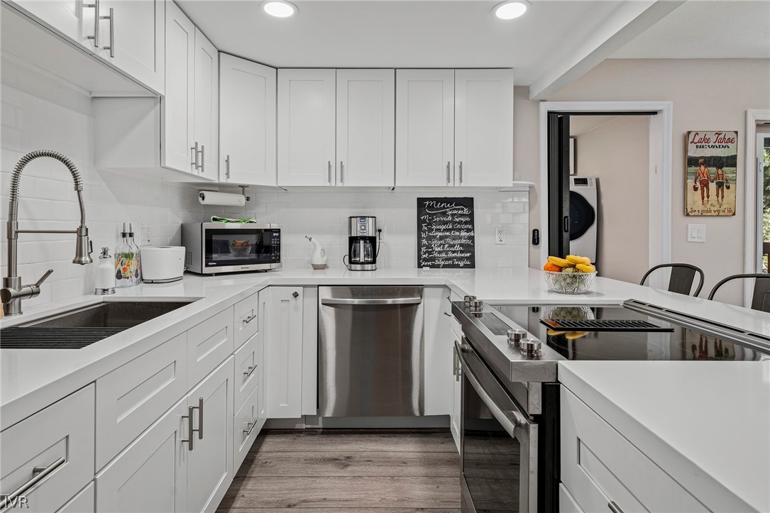 806 Oriole Way, Unit 16 Incline Village, NV 89451 - Photo 7 of 17 a kitchen with stainless steel appliances granite countertop a stove a sink and a white cabinets