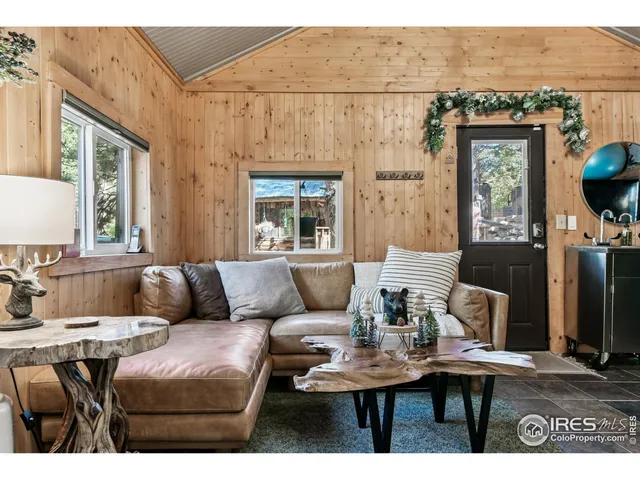 a bedroom with a bed couch and a large window