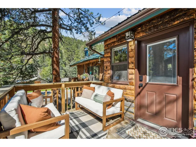 front view of house with a chairs and table in the patio