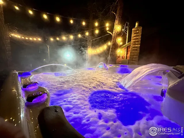 a view of a chairs and table in the backyard