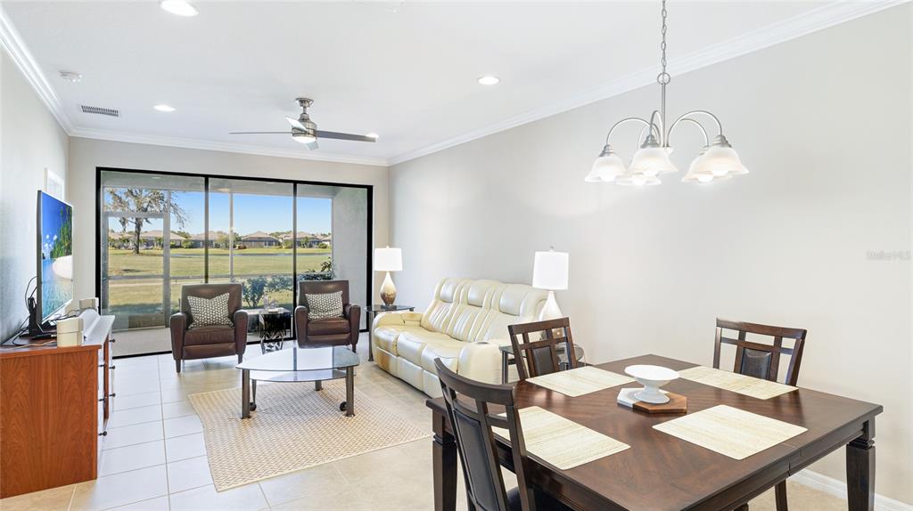 13719 Messina Loop, Unit 101 Lakewood Ranch, FL 34211 - Photo 15 of 77 a living room with furniture a lamp and a large window