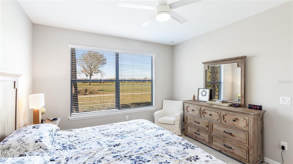 13719 Messina Loop, Unit 101 Lakewood Ranch, FL 34211 - Photo 23 of 77 a bedroom with a bed and a dresser