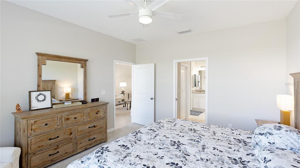 13719 Messina Loop, Unit 101 Lakewood Ranch, FL 34211 - Photo 24 of 77 a bedroom with a bed and a dresser in it