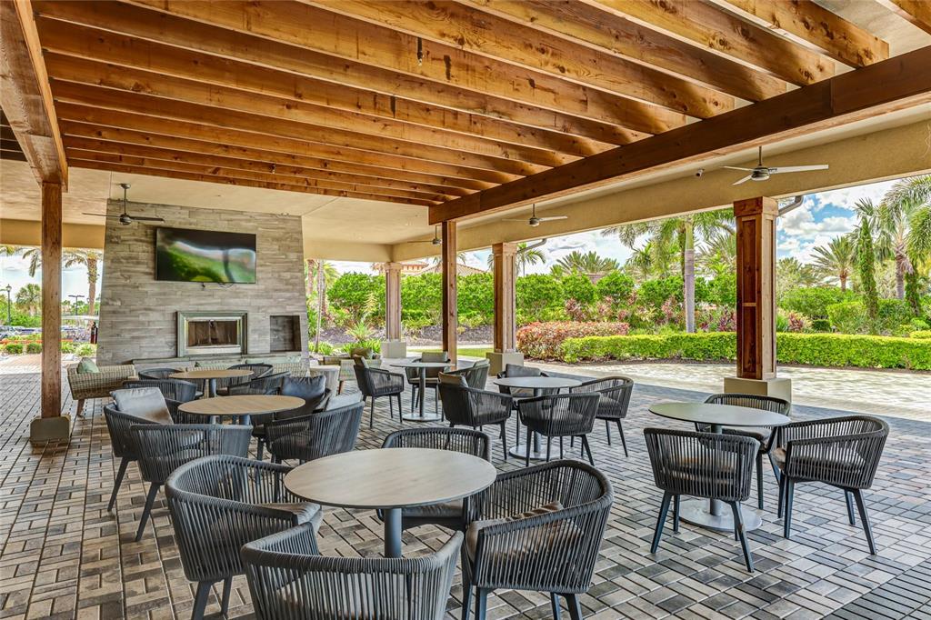 13719 Messina Loop, Unit 101 Lakewood Ranch, FL 34211 - Photo 56 of 77 a view of a dining room with furniture wooden floor and a potted plant