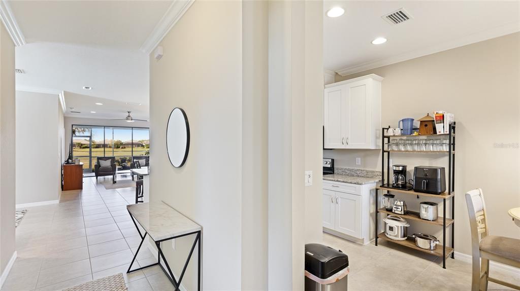 13719 Messina Loop, Unit 101 Lakewood Ranch, FL 34211 - Photo 6 of 77 a living room with furniture a flat screen tv and view of kitchen