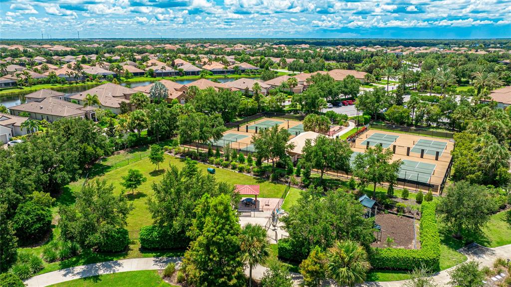 13719 Messina Loop, Unit 101 Lakewood Ranch, FL 34211 - Photo 66 of 77 an aerial view of residential houses with outdoor space and trees