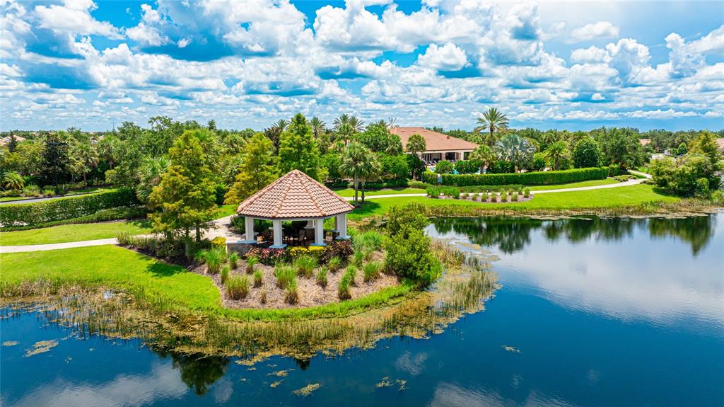 13719 Messina Loop, Unit 101 Lakewood Ranch, FL 34211 - Photo 68 of 77 a view of a lake with a house in the background