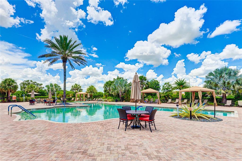 13719 Messina Loop, Unit 101 Lakewood Ranch, FL 34211 - Photo 72 of 77 a view of a table and chairs in patio with a yard