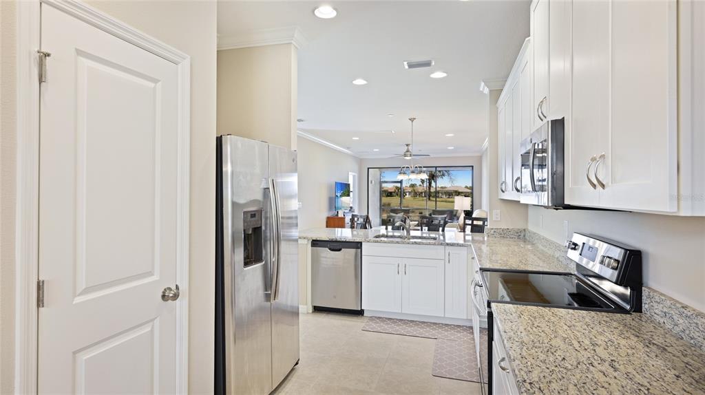 13719 Messina Loop, Unit 101 Lakewood Ranch, FL 34211 - Photo 10 of 77 a kitchen with stainless steel appliances granite countertop a refrigerator and a sink