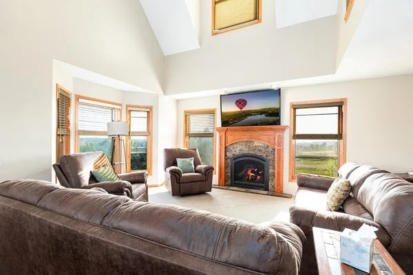 a bedroom with a large bed and a chandelier