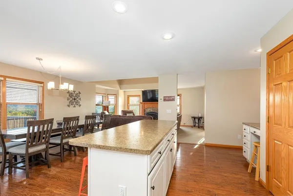 a dining room with furniture and wooden floor