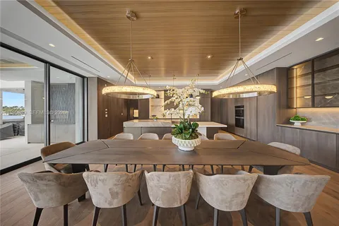 a living room with stainless steel appliances granite countertop furniture and a kitchen view