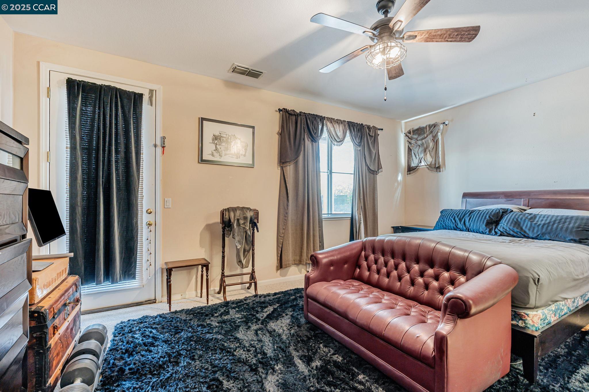 20640 Sarazen Place Patterson, CA 95363 - Photo 11 of 28 a living room with furniture a ceiling fan and a rug