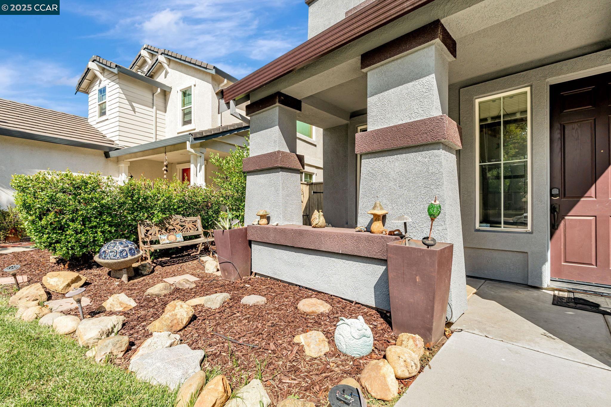 20640 Sarazen Place Patterson, CA 95363 - Photo 2 of 28 a view of a patio with couches table and chairs and potted plants
