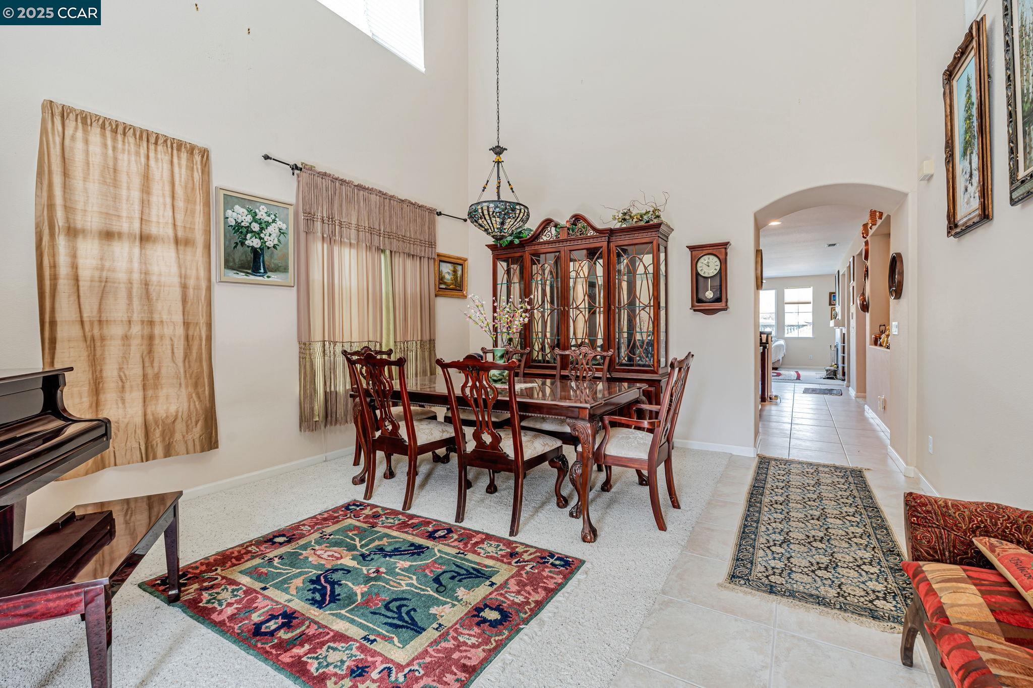 20640 Sarazen Place Patterson, CA 95363 - Photo 5 of 28 a dining room with furniture a rug and wooden floor