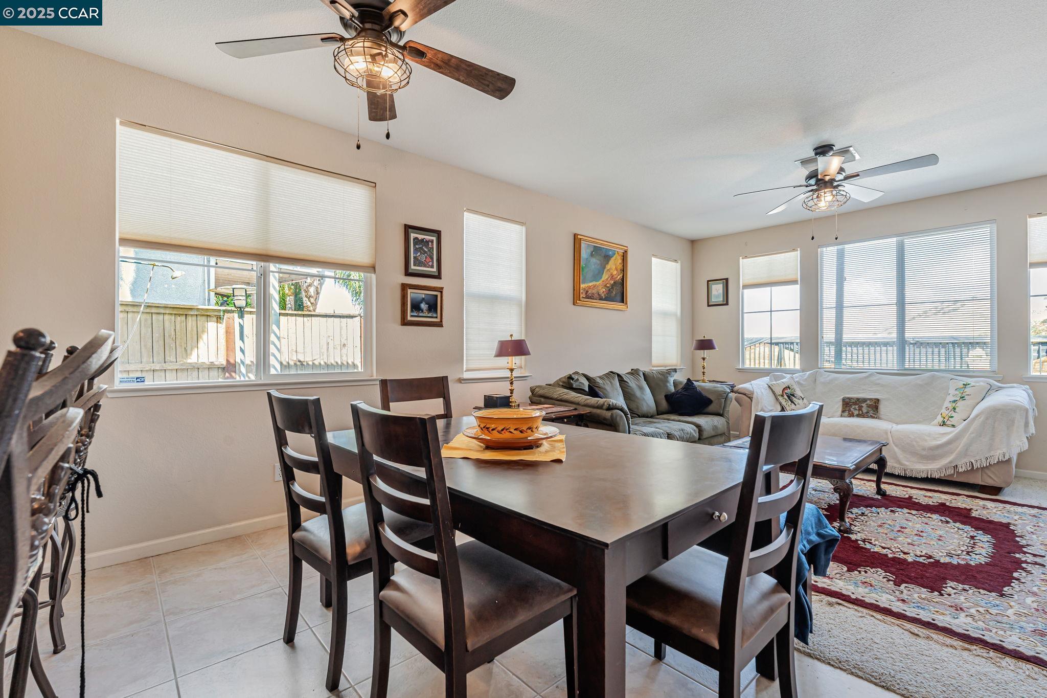 20640 Sarazen Place Patterson, CA 95363 - Photo 8 of 28 a dining room with furniture a chandelier and a rug