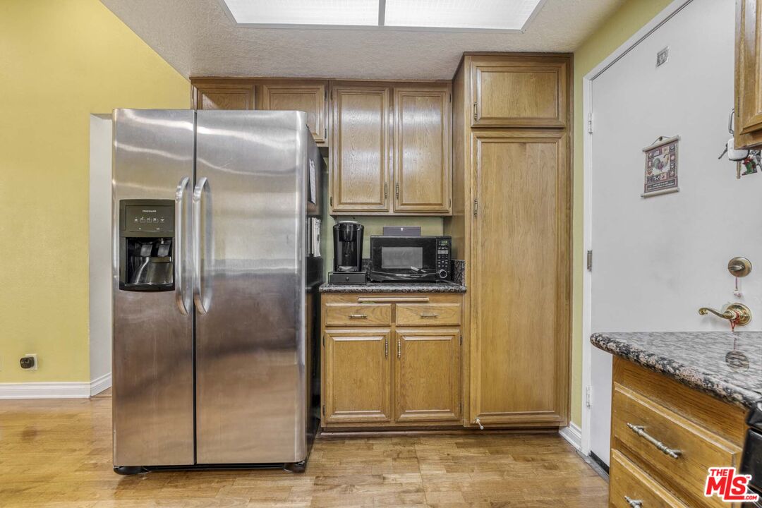 28135 Royal Road Castaic, CA 91384 - Photo 12 of 37 a kitchen with granite countertop a refrigerator and a sink