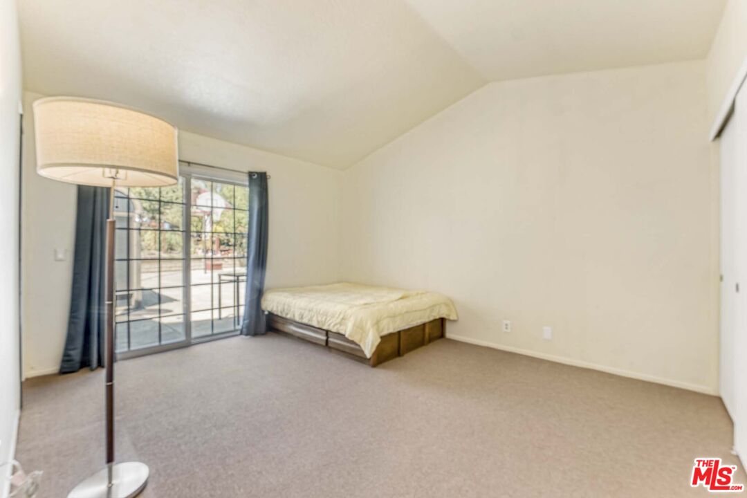 28135 Royal Road Castaic, CA 91384 - Photo 17 of 37 a spacious bedroom with a bed and a couch