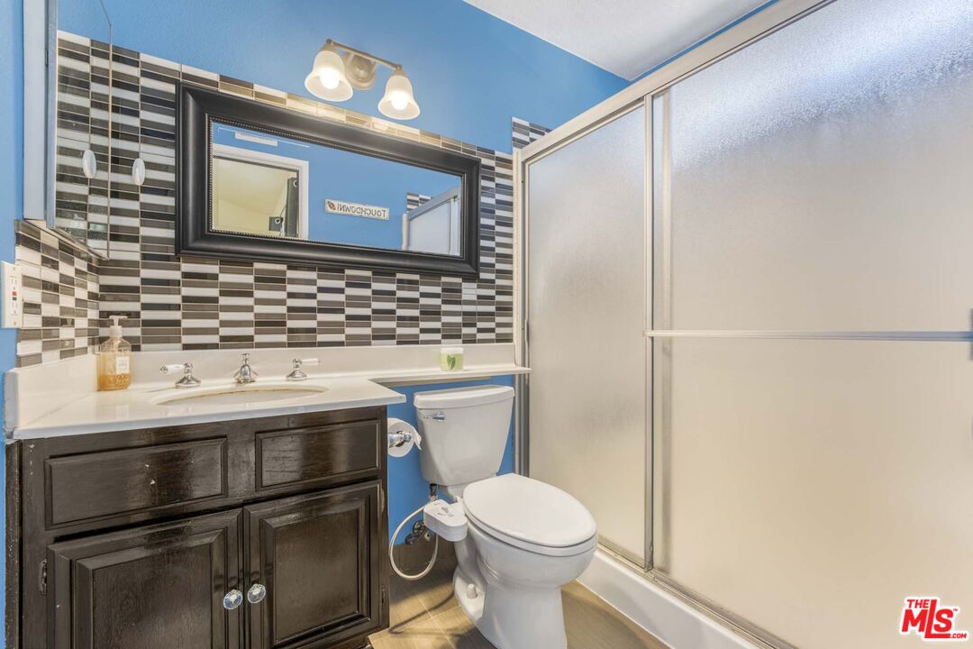 28135 Royal Road Castaic, CA 91384 - Photo 21 of 37 a bathroom with a toilet a sink and a shower