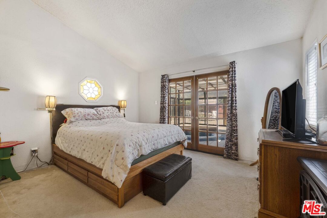 28135 Royal Road Castaic, CA 91384 - Photo 23 of 37 a bedroom with a bed and a flat tv screen on dresser