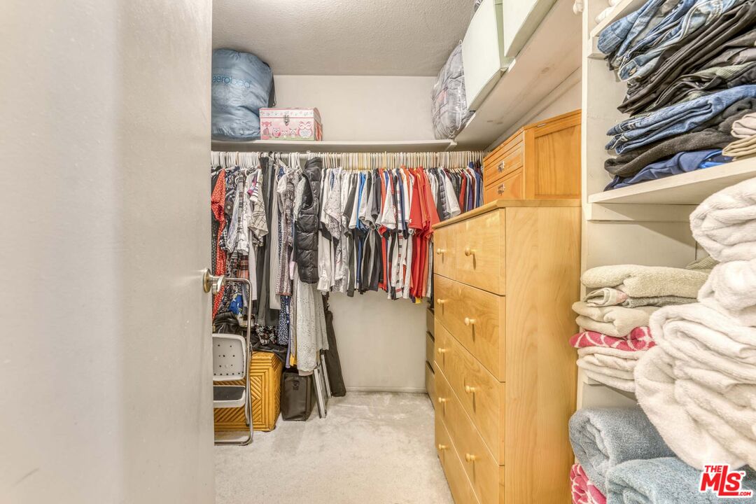 28135 Royal Road Castaic, CA 91384 - Photo 24 of 37 a view of walk in closet with clothes and shoes
