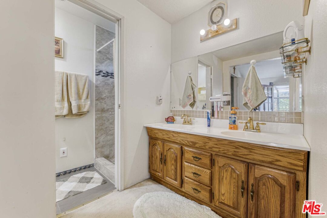 28135 Royal Road Castaic, CA 91384 - Photo 25 of 37 a spacious bathroom with a double vanity sink double vanity and mirror