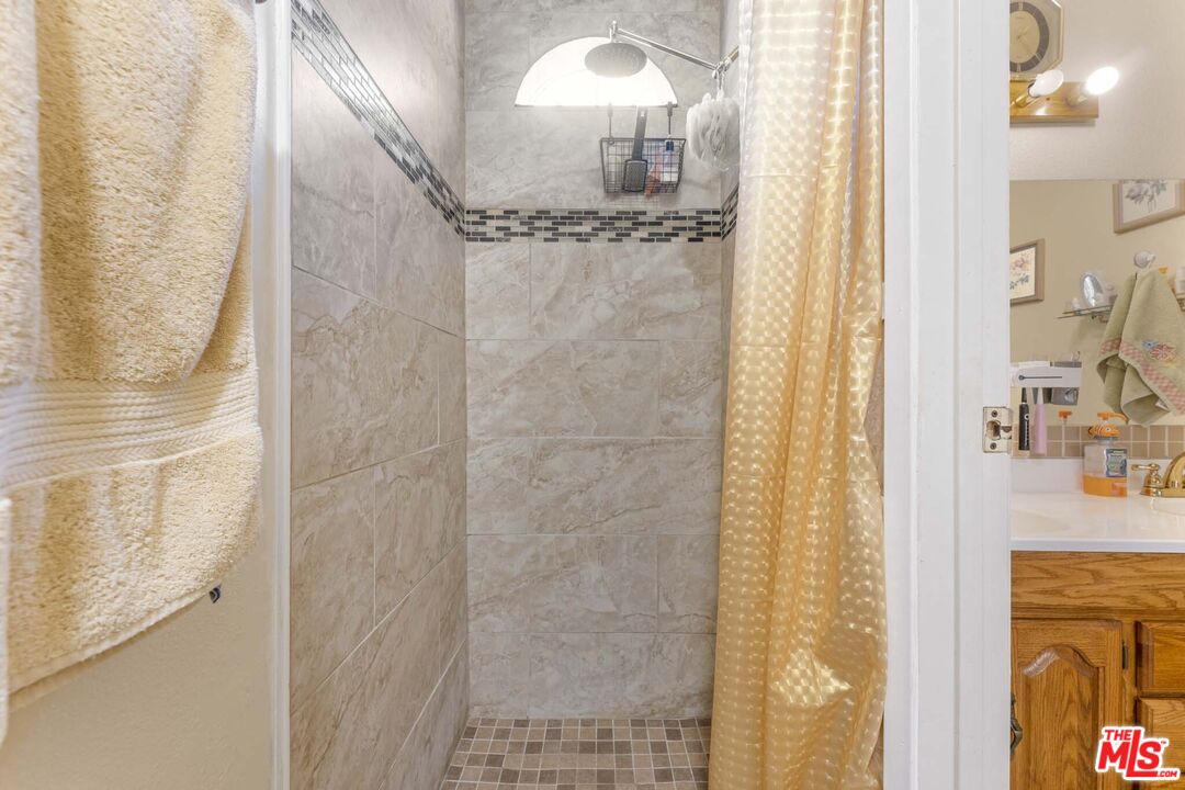 28135 Royal Road Castaic, CA 91384 - Photo 26 of 37 a bathroom with a mirror and a shower