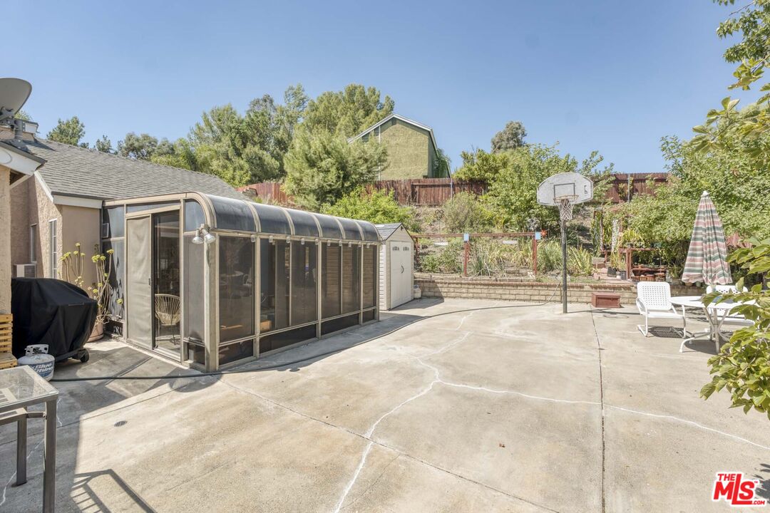 28135 Royal Road Castaic, CA 91384 - Photo 30 of 37 a view of a backyard house with large trees and plants