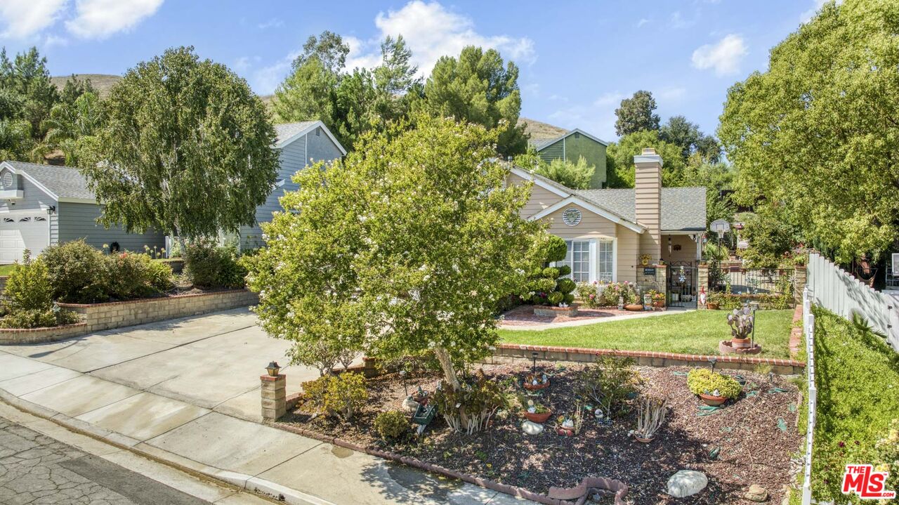 28135 Royal Road Castaic, CA 91384 - Photo 3 of 37 a front view of a house with garden