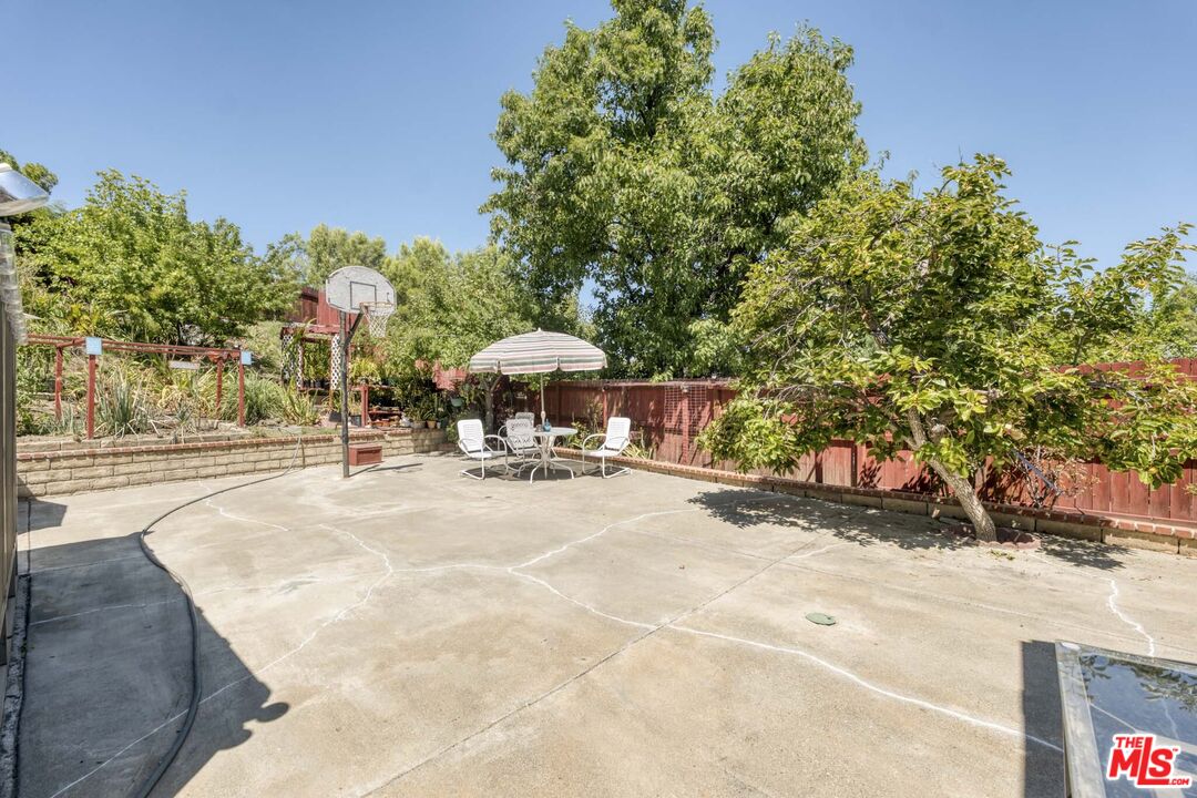 28135 Royal Road Castaic, CA 91384 - Photo 31 of 37 a view of a swimming pool with an outdoor space and seating area