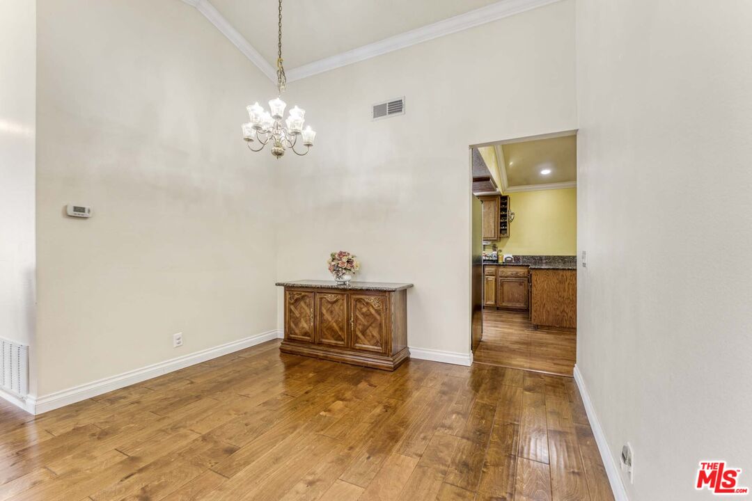 28135 Royal Road Castaic, CA 91384 - Photo 7 of 37 a view of a room with cabinet and wooden floor