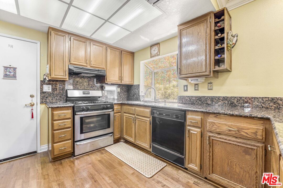 28135 Royal Road Castaic, CA 91384 - Photo 10 of 37 a kitchen with stainless steel appliances granite countertop a stove sink and cabinets