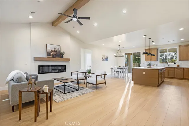 a living room with furniture and kitchen view