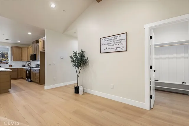 a kitchen with stainless steel appliances kitchen island granite countertop a kitchen island a stove a table and chairs in it