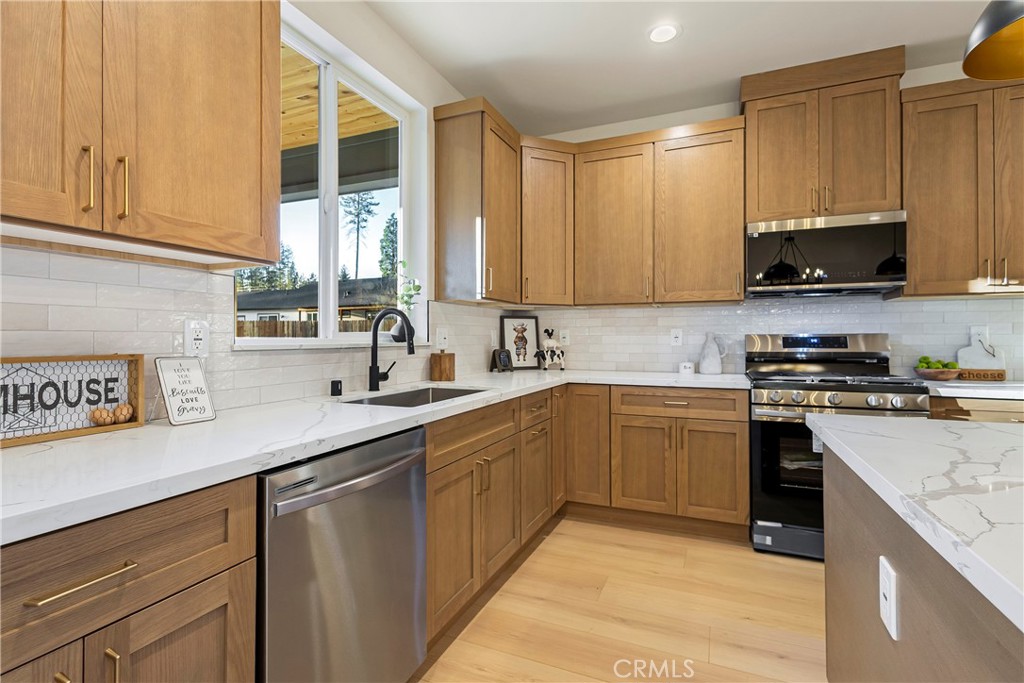 6185 Pentz Road Paradise, CA 95969 - Photo 17 of 53 a kitchen with stainless steel appliances granite countertop a sink a stove and a microwave
