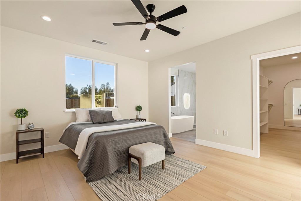 6185 Pentz Road Paradise, CA 95969 - Photo 21 of 53 a bedroom with a bed and a chandelier