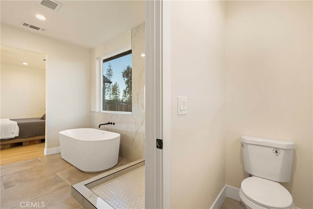 6185 Pentz Road Paradise, CA 95969 - Photo 23 of 53 a spacious bathroom with a toilet sink and mirror