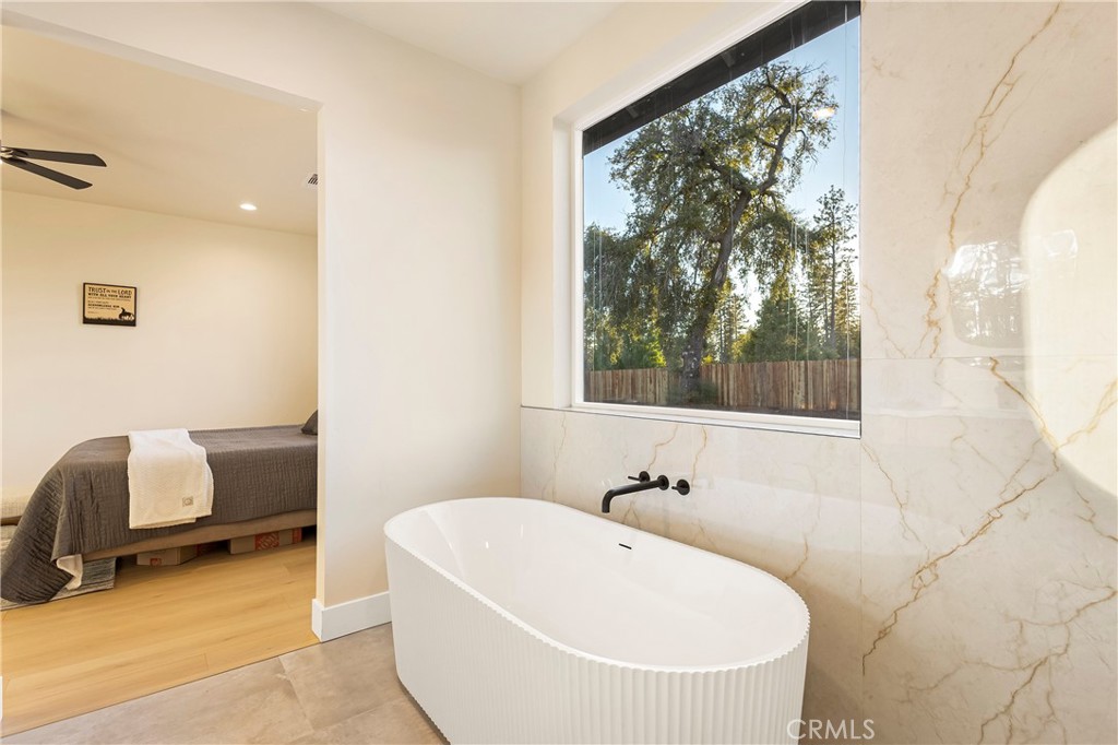 6185 Pentz Road Paradise, CA 95969 - Photo 25 of 53 a white bath tub sitting in a bathroom next to a window