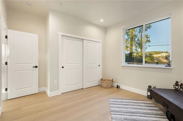 a view of cabinets and utility room with wooden floor