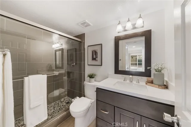 a bedroom with a bed and glass window