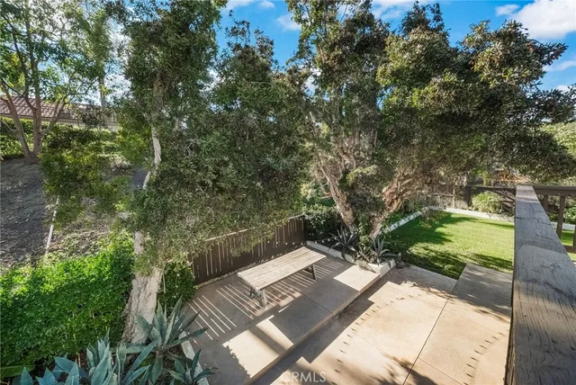a patio with yard glass top table and chairs