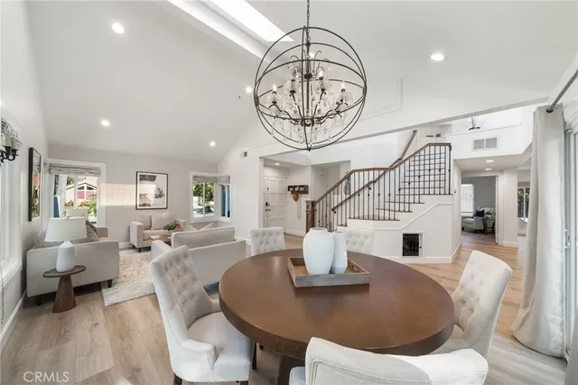 a living room with furniture a rug and white walls