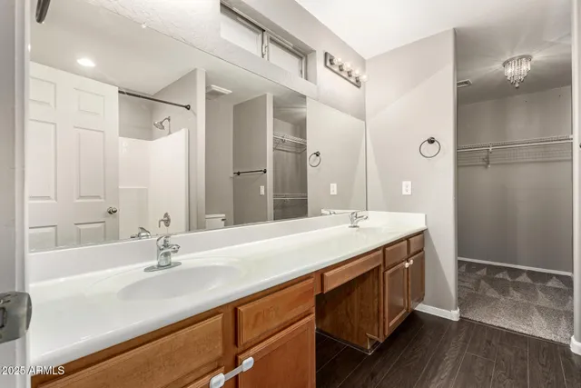 a bathroom with a double vanity sink mirror and shower