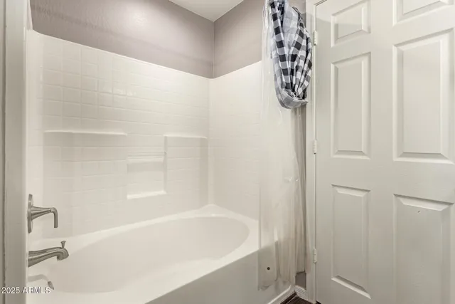 a bathroom with a bathtub and shower