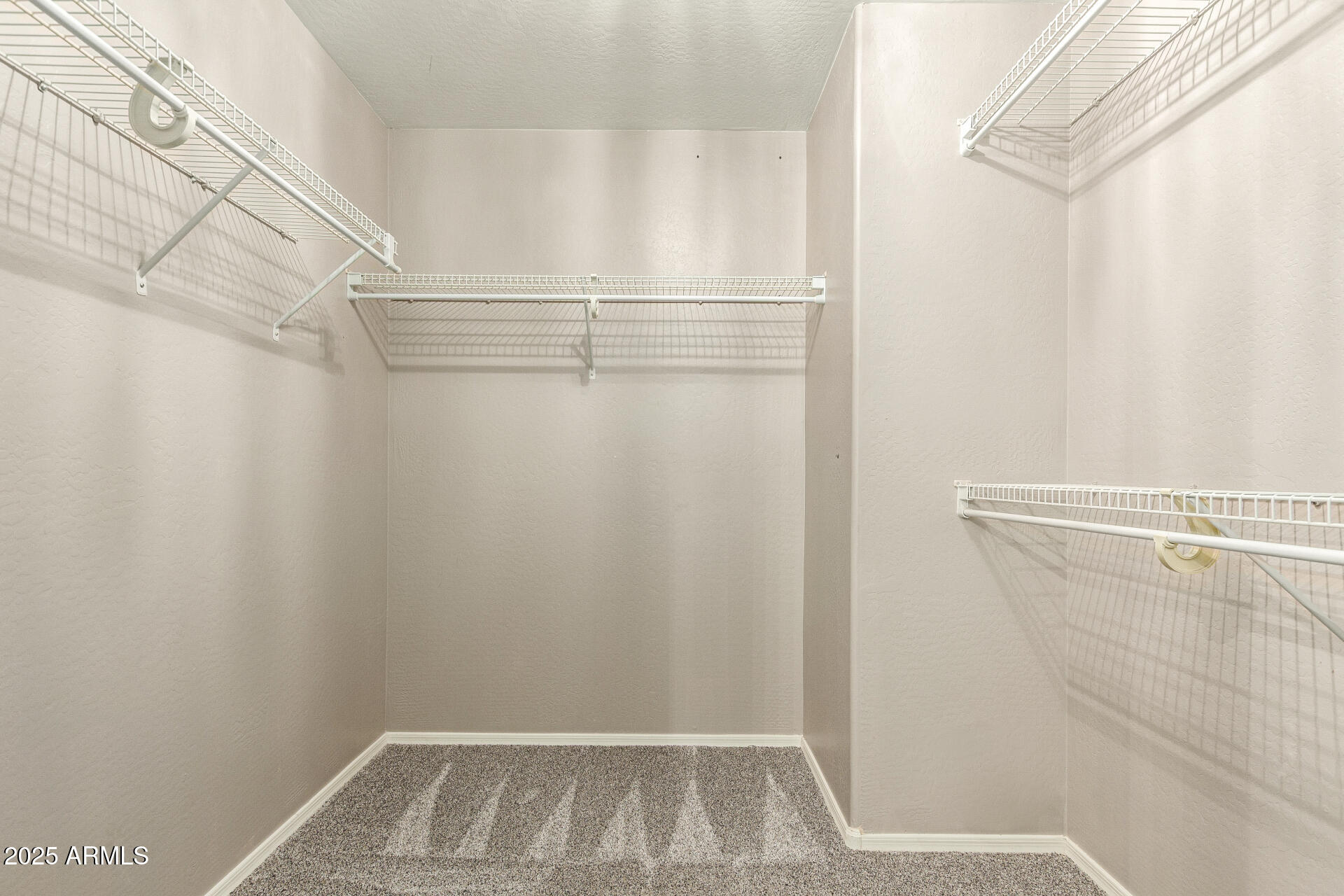 161 South 21st Street Coolidge, AZ 85128 - Photo 19 of 32 a view of walk in closet with clothes