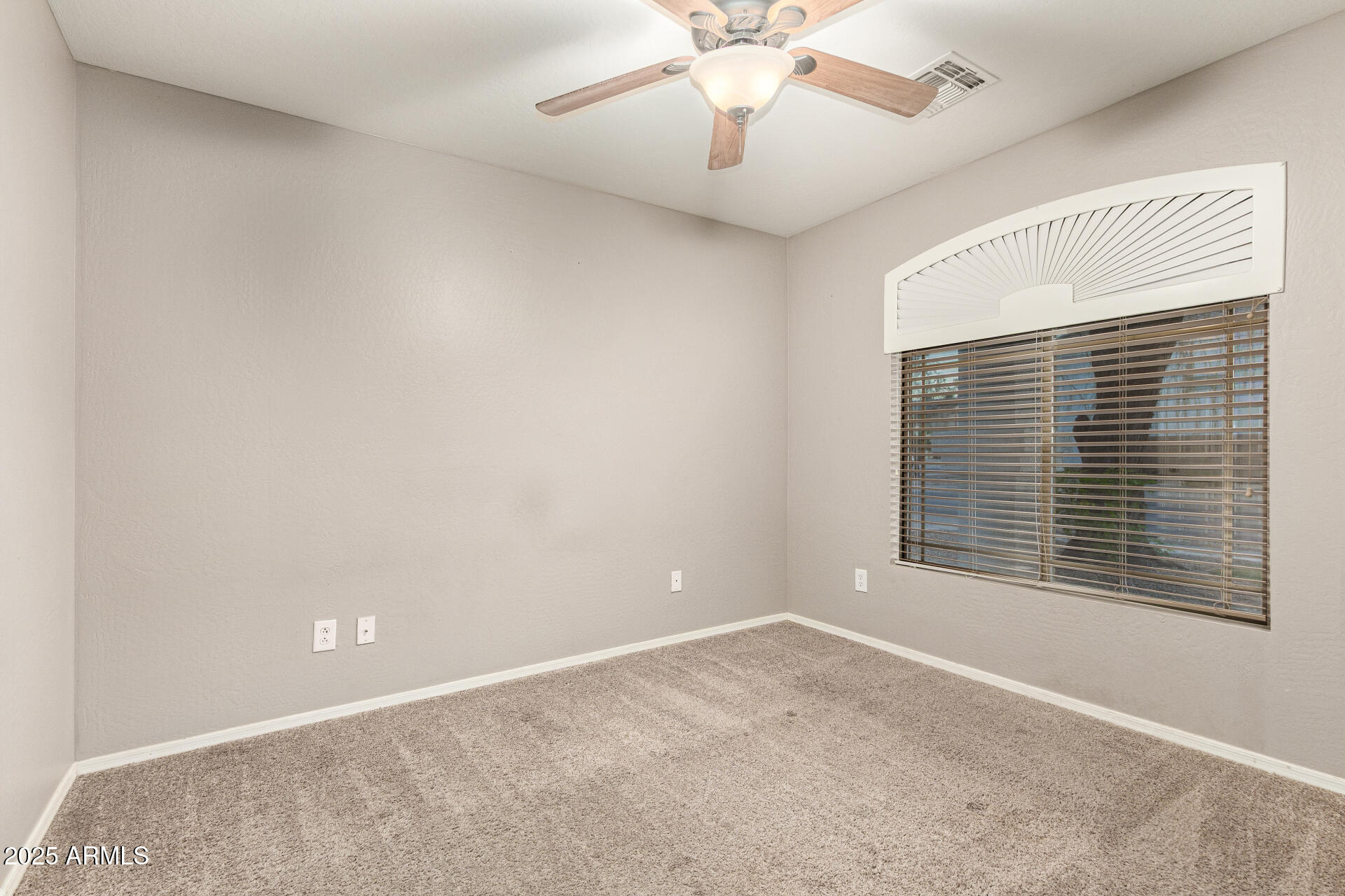 161 South 21st Street Coolidge, AZ 85128 - Photo 21 of 32 en empty room with windows and chandelier fan