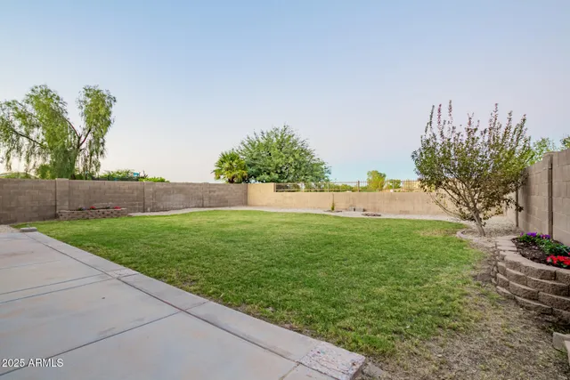 a view of yard with swimming pool and trees in the background