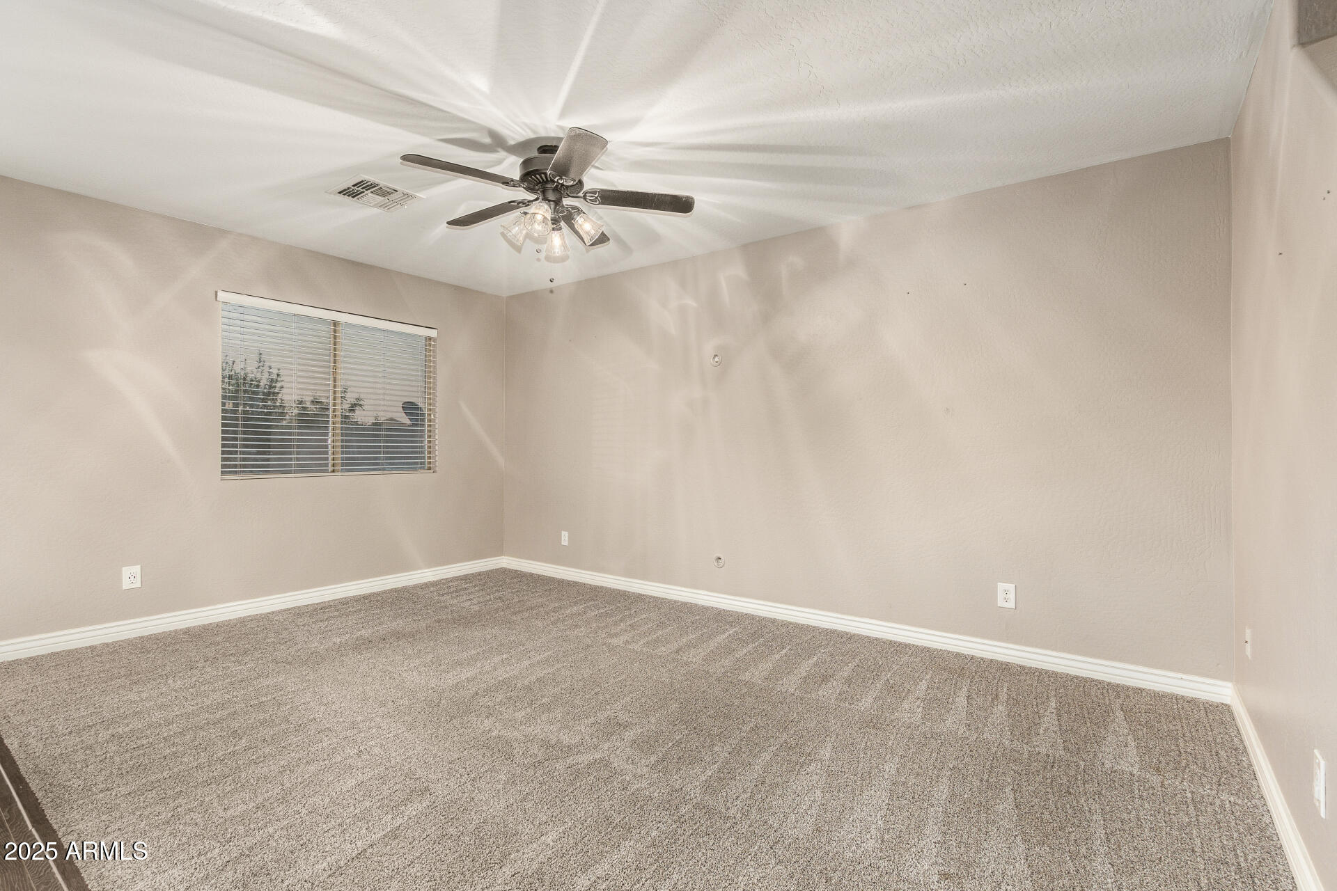 161 South 21st Street Coolidge, AZ 85128 - Photo 3 of 32 an empty room with windows and fan