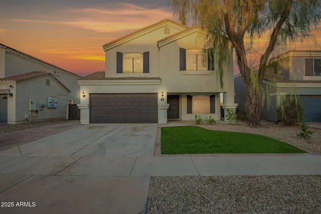 a front view of a house with a yard and a garage